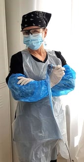 Tanya Magdalena posing in sanitary, protective suit during COVID-19.