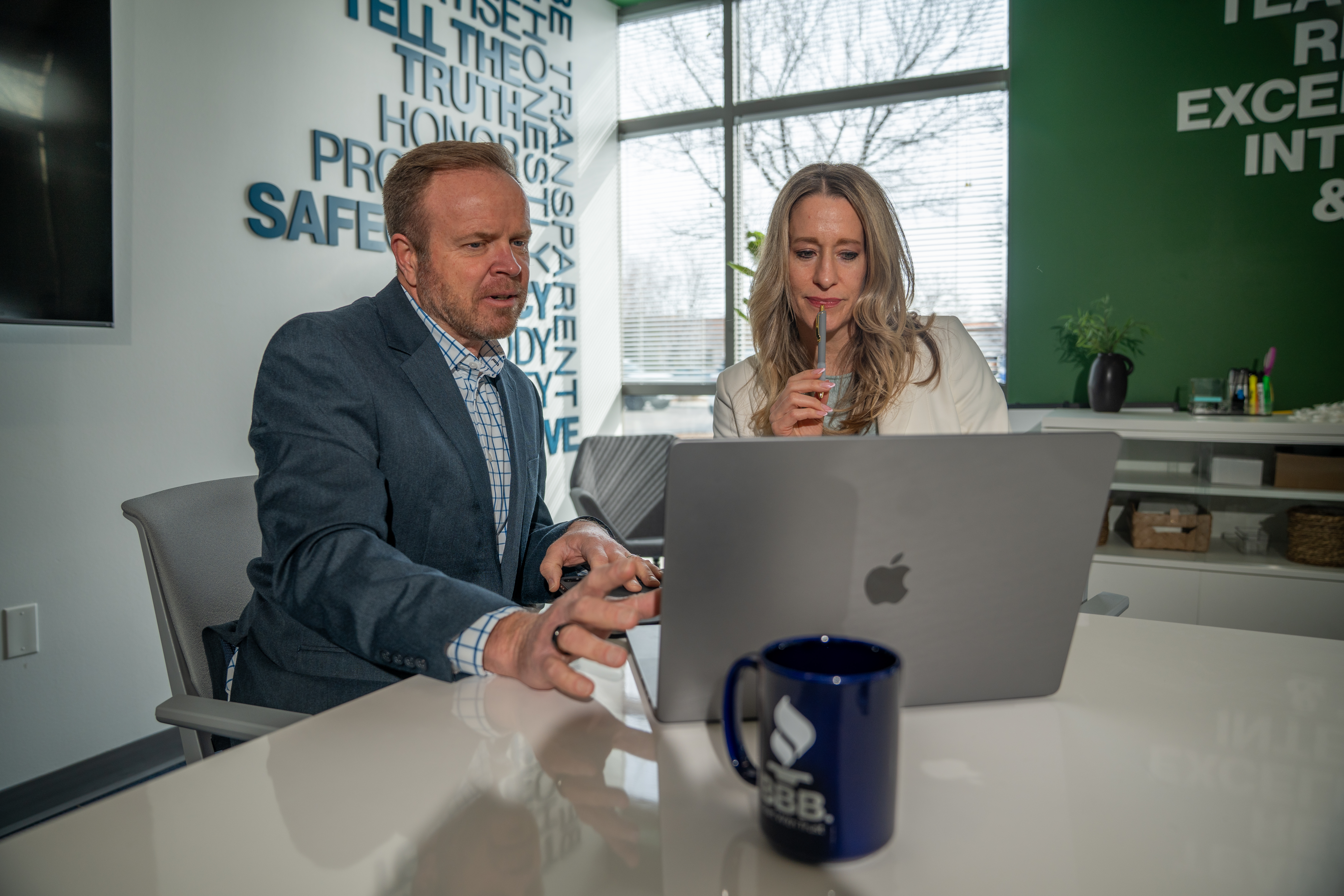 Two professionals looking at a computer